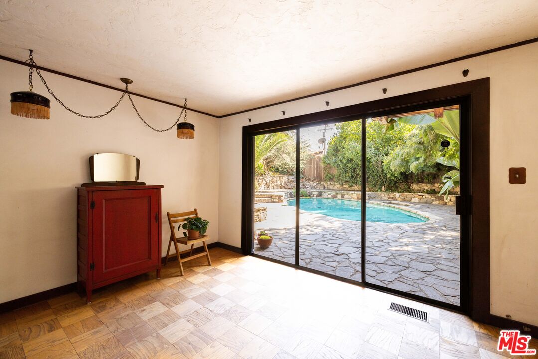 1748 Laurel Canyon Boulevard Los Angeles, CA 90046 - Photo 14 of 24 a view of a room with gym equipment and large windows