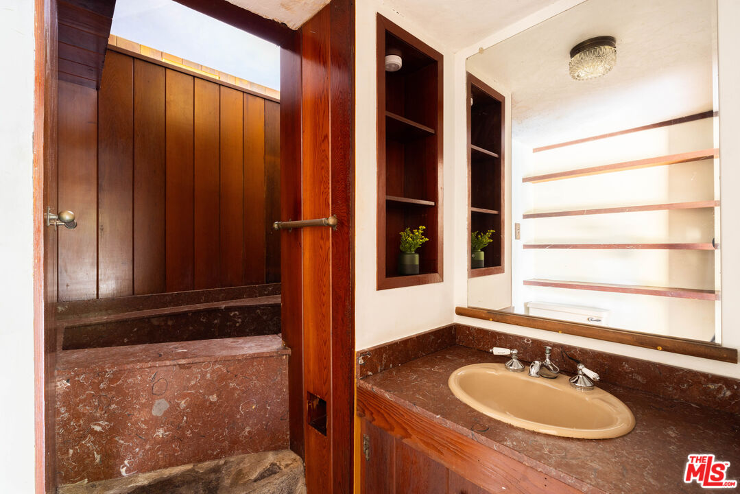1748 Laurel Canyon Boulevard Los Angeles, CA 90046 - Photo 15 of 24 a bathroom with a sink and a mirror