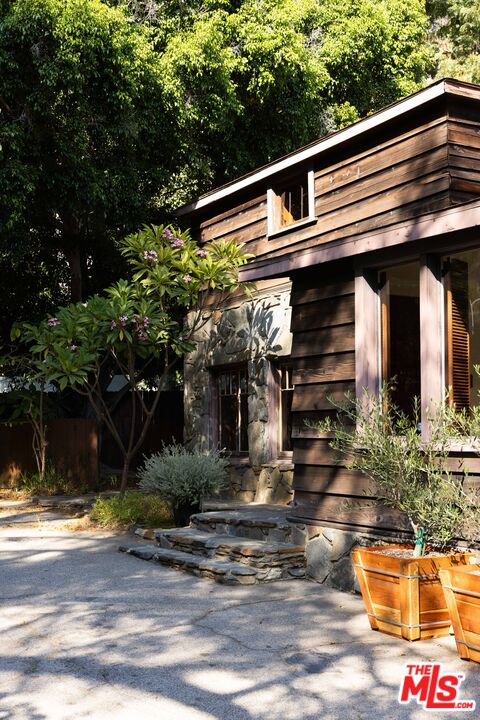 1748 Laurel Canyon Boulevard Los Angeles, CA 90046 - Photo 23 of 24 a front view of a house with garden