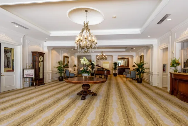 a view of a room with gym equipment and wooden floor