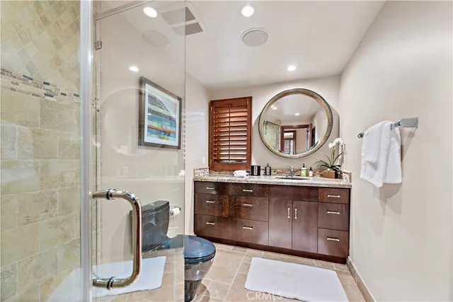 a bathroom with a sink a toilet and a shower