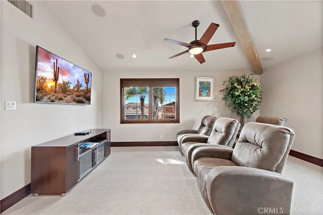 a living room with furniture and a ceiling fan