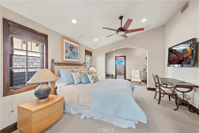 a bedroom with a bed gym equipment and a large window