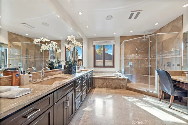 a spacious bathroom with a granite countertop sink and a large mirror