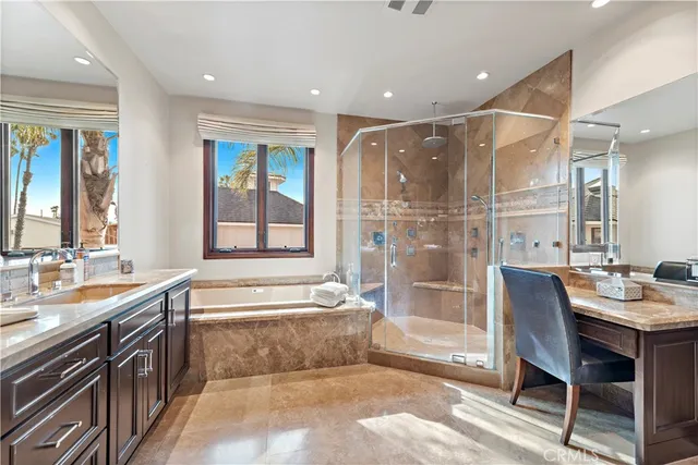 a bathroom with a tub sink and mirror