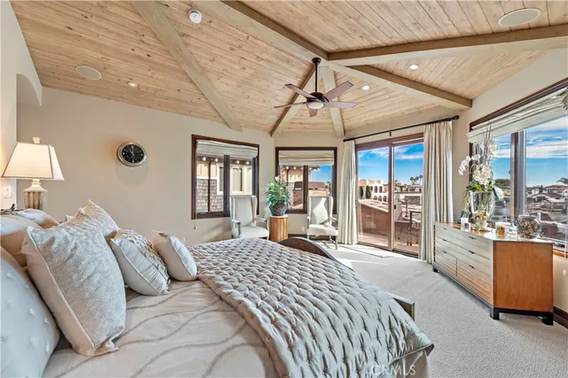 a bedroom with large bed and wooden floor