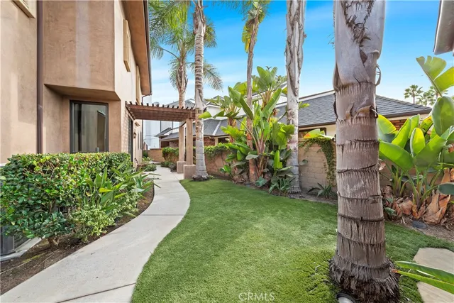 a front view of a house with yard and trees