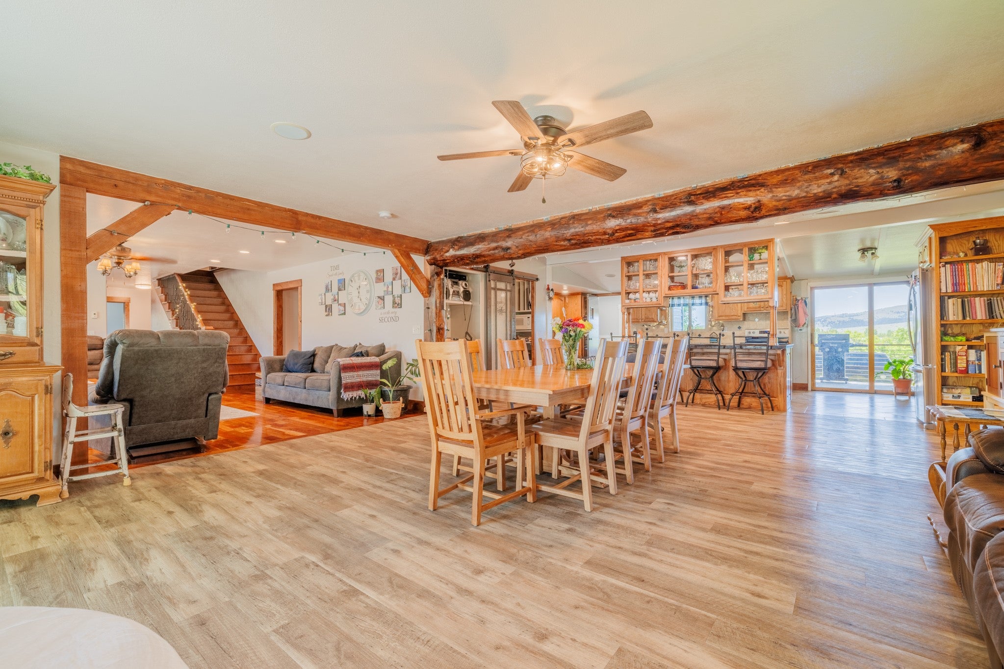 58 Gilman Road Garrison, MT 59731 - Photo 32 of 91 Dining room with a ceiling fan, light wood-style floors, and beamed ceiling