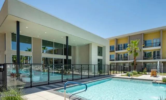 a swimming pool with outdoor seating and yard
