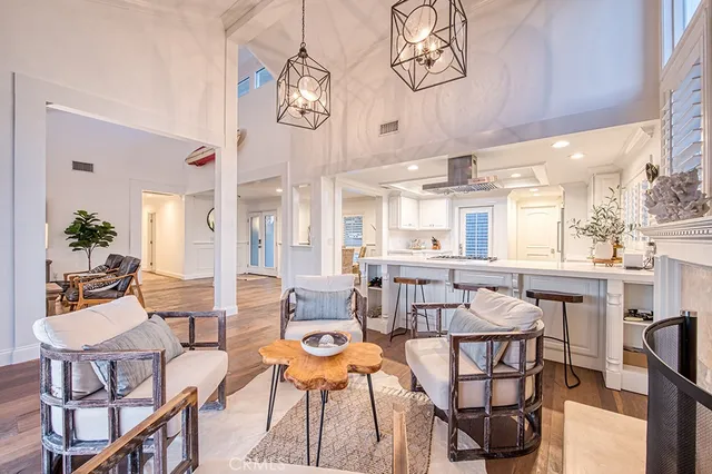 a view of a dining room with furniture a chandelier and wooden floor