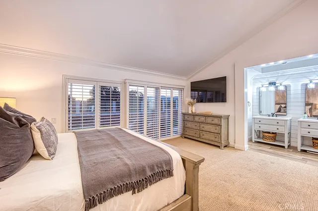 a bedroom with a bed a television and dresser