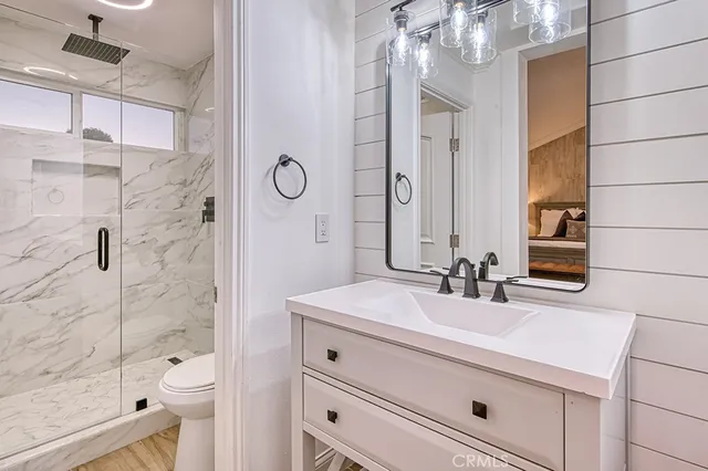 a bathroom with a double vanity sink toilet and shower