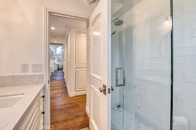 a bathroom with a sink and a glass door shower