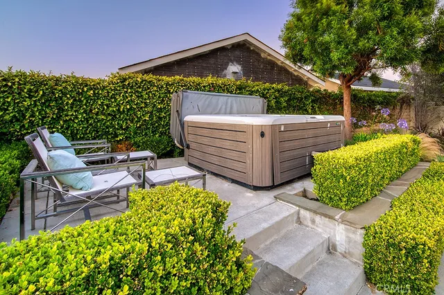 a view of a chairs and tables in the back yard of the house