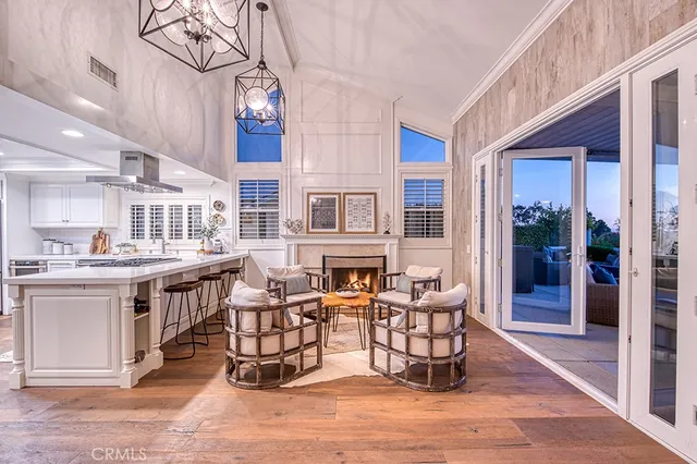 a living room with fireplace furniture and a chandelier