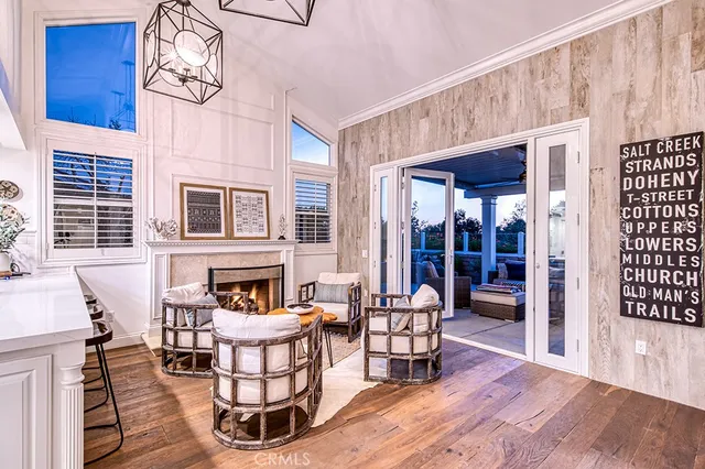 a living room with furniture a fireplace and wooden floor