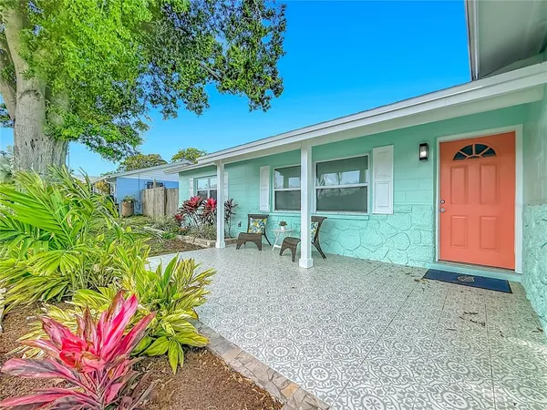 a view of a house with potted plants in front of door