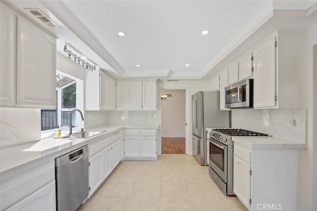 5974 Ruthwood Drive Calabasas, CA 91302 - Photo 2 of 30 a kitchen with stainless steel appliances a sink stove and refrigerator