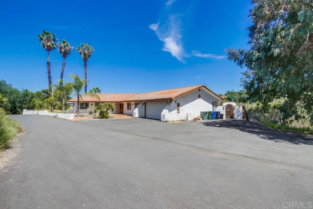 766 South Grade Road Alpine, CA 91901 - Photo 1 of 1 a front view of a house with a yard and a garage