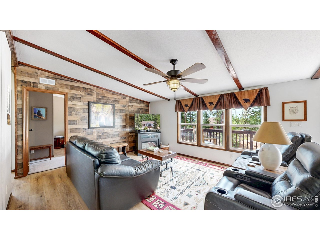 62 Spokane Court Red Feather Lakes, CO 80545 - Photo 5 of 38 a living room with furniture and a large window