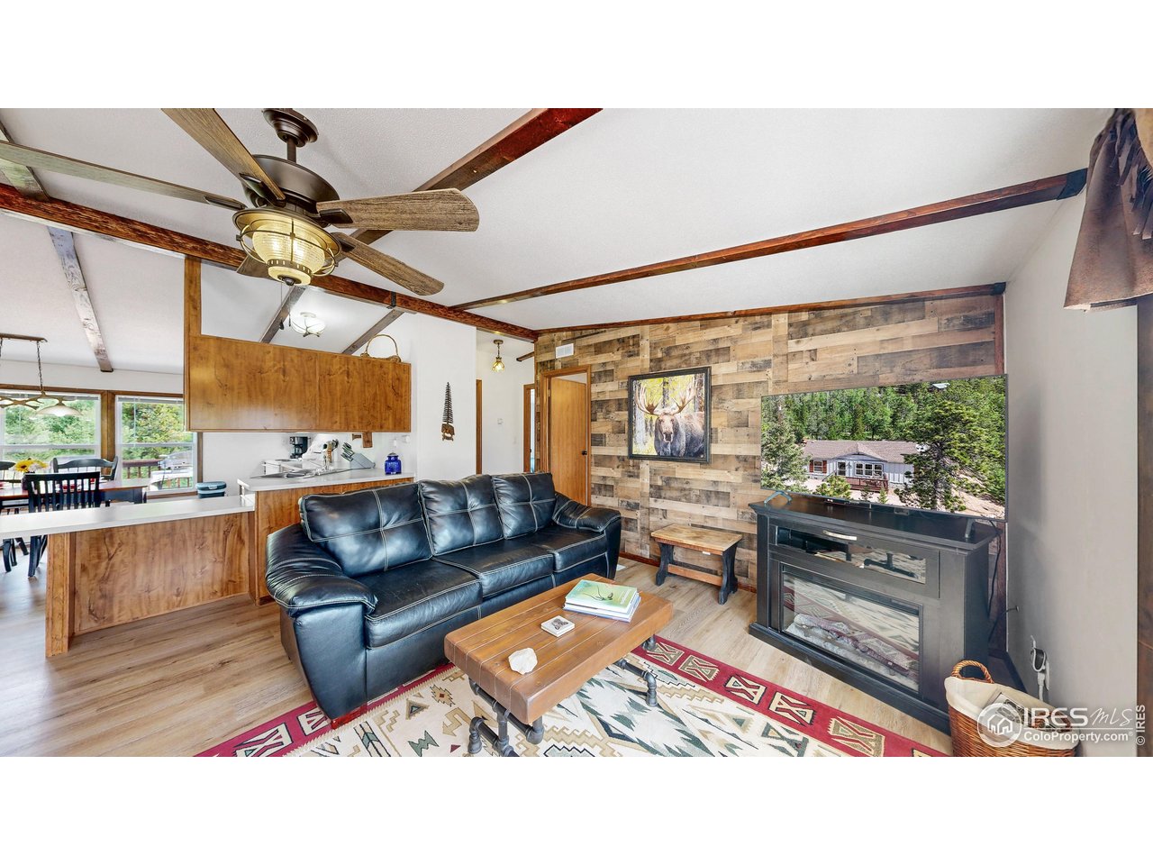 62 Spokane Court Red Feather Lakes, CO 80545 - Photo 6 of 38 a living room with furniture and a large window