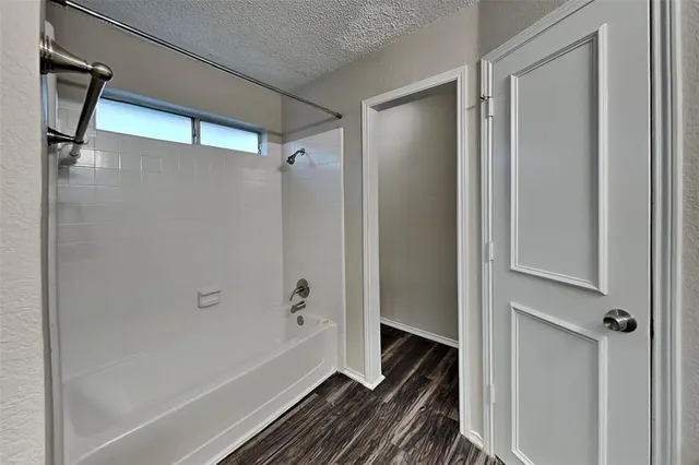 a bathroom with a bathtub and a shower