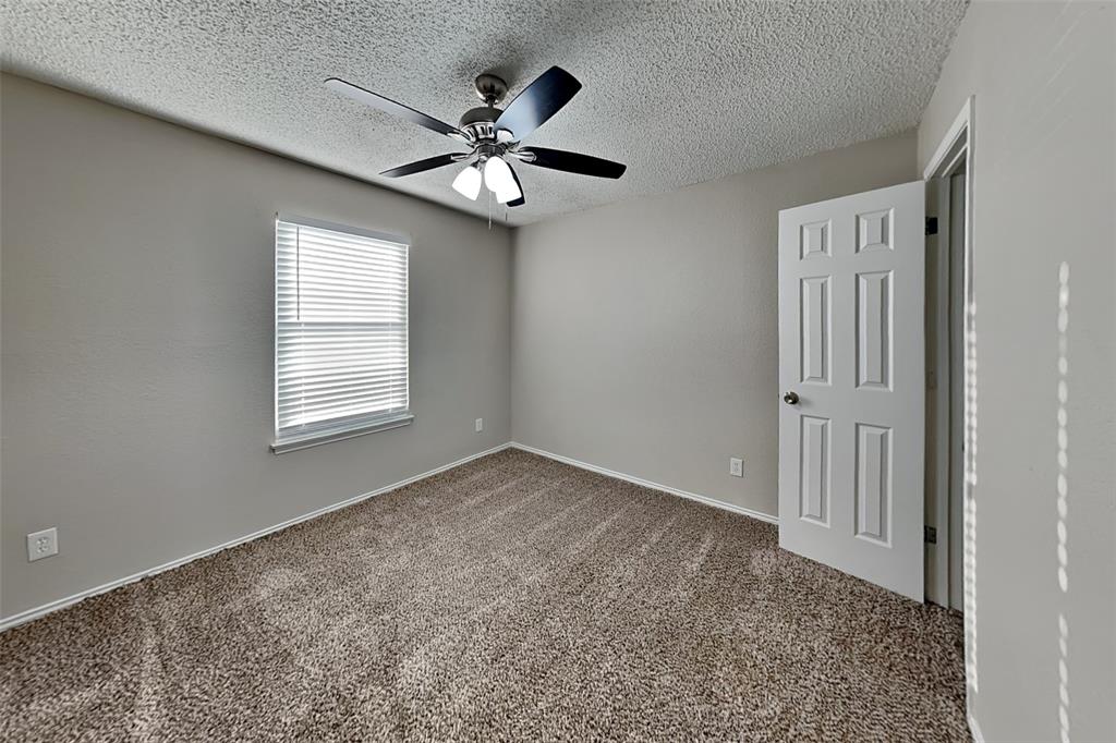 7836 Prairie Drive Watauga, TX 76148 - Photo 12 of 20 an empty room with windows and fan