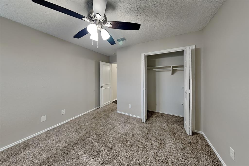 7836 Prairie Drive Watauga, TX 76148 - Photo 15 of 20 an empty room with closet and a ceiling fan