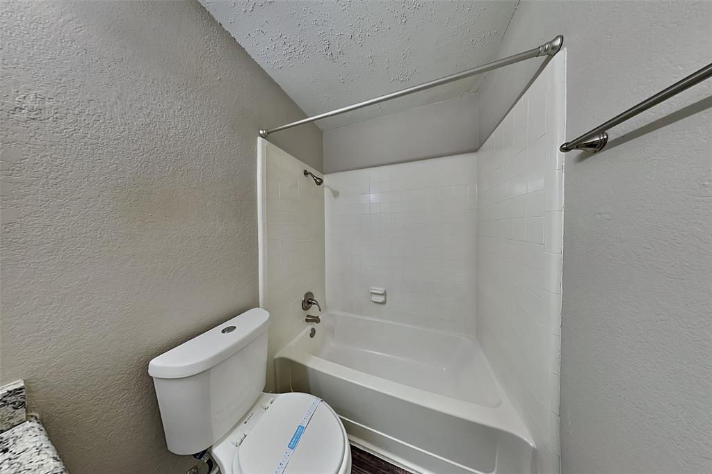 7836 Prairie Drive Watauga, TX 76148 - Photo 18 of 20 a bathroom with a toilet and a bathtub