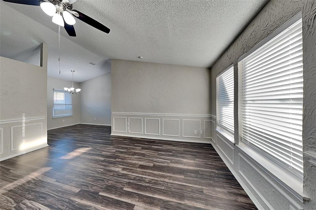 7836 Prairie Drive Watauga, TX 76148 - Photo 3 of 20 a view of an empty room with wooden floor and a window