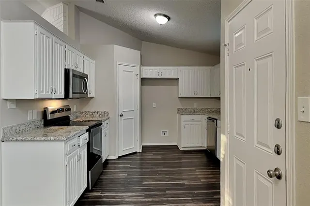 a kitchen with stainless steel appliances granite countertop a stove and a refrigerator