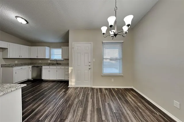 a view of a kitchen with sink cabinets and wooden floor