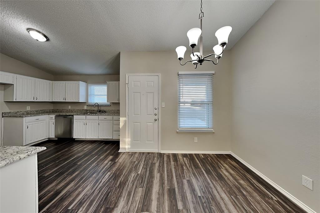 7836 Prairie Drive Watauga, TX 76148 - Photo 7 of 20 a view of a kitchen with sink cabinets and wooden floor