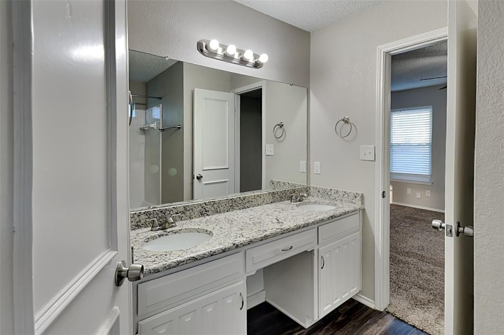 7836 Prairie Drive Watauga, TX 76148 - Photo 10 of 20 a bathroom with a granite countertop sink and a mirror