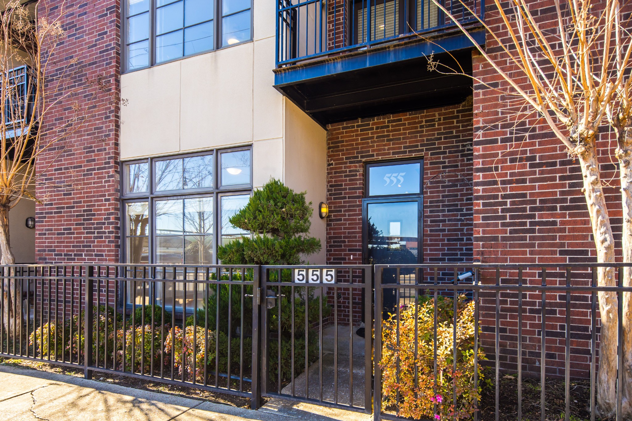 a view of a brick house with many windows