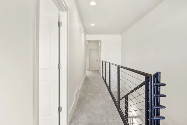 a view of a hallway with wooden floor and entryway