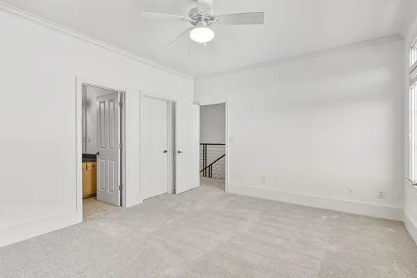 a view of an empty room with a ceiling fan