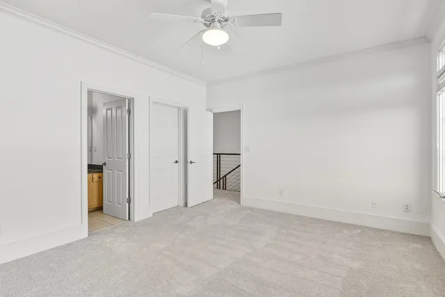 a view of an empty room with a ceiling fan