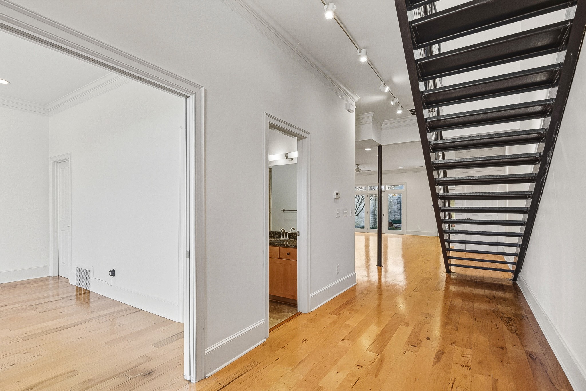 555 South Front Street Memphis, TN 38103 - Photo 2 of 31 a view of a hallway with wooden floor and staircase