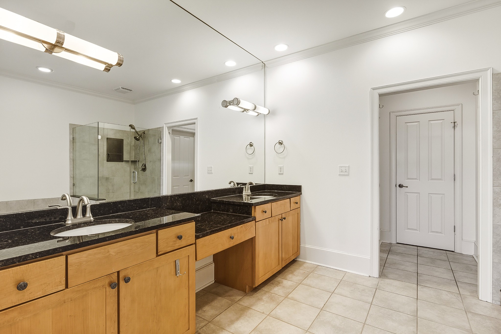 555 South Front Street Memphis, TN 38103 - Photo 26 of 31 a spacious bathroom with a granite countertop sink a mirror and a