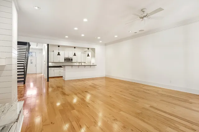 a view of a kitchen with wooden floor and a sink