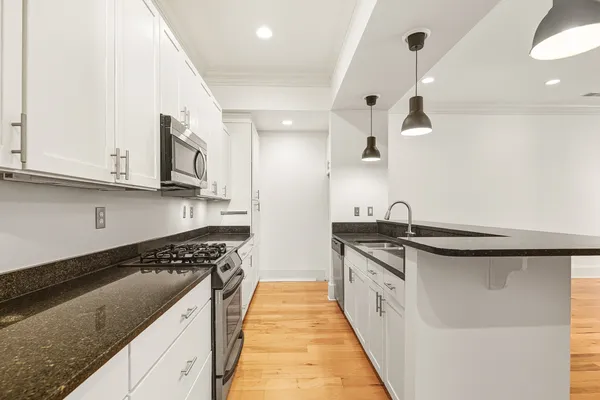a kitchen with stainless steel appliances granite countertop a sink and stove