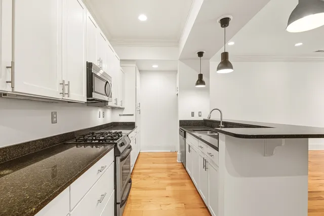 a kitchen with stainless steel appliances granite countertop a sink and stove