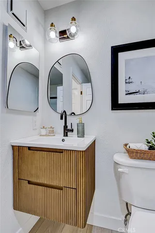 a bathroom with a toilet a sink and mirror