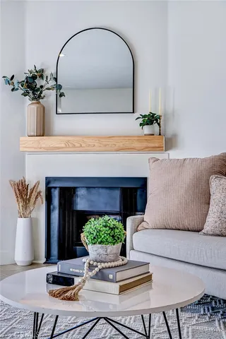 a living room with furniture and potted plants