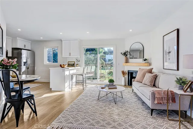 a living room with furniture a dining table and a fireplace