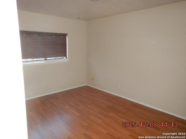 8931 Dakota Run Converse, TX 78109 - Photo 13 of 13 a view of an empty room with wooden floor and a window
