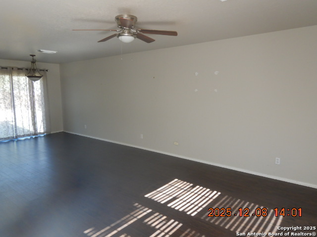 8931 Dakota Run Converse, TX 78109 - Photo 3 of 13 an empty room with wooden floor fan and windows