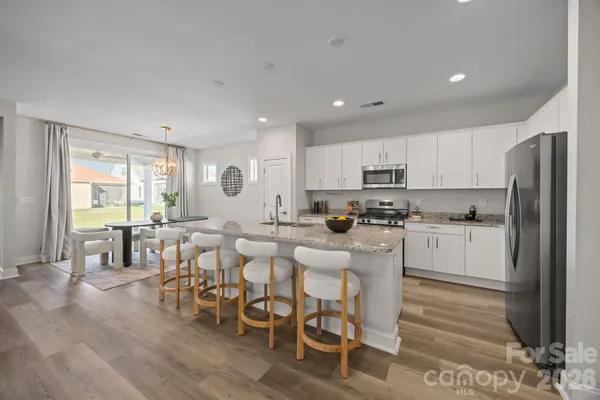 a kitchen with a stove a sink and a microwave