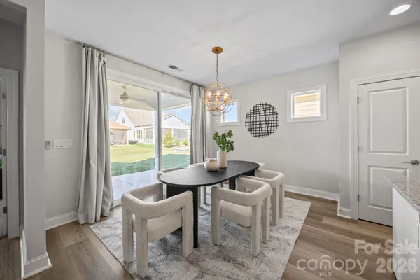 a dining room with furniture and window